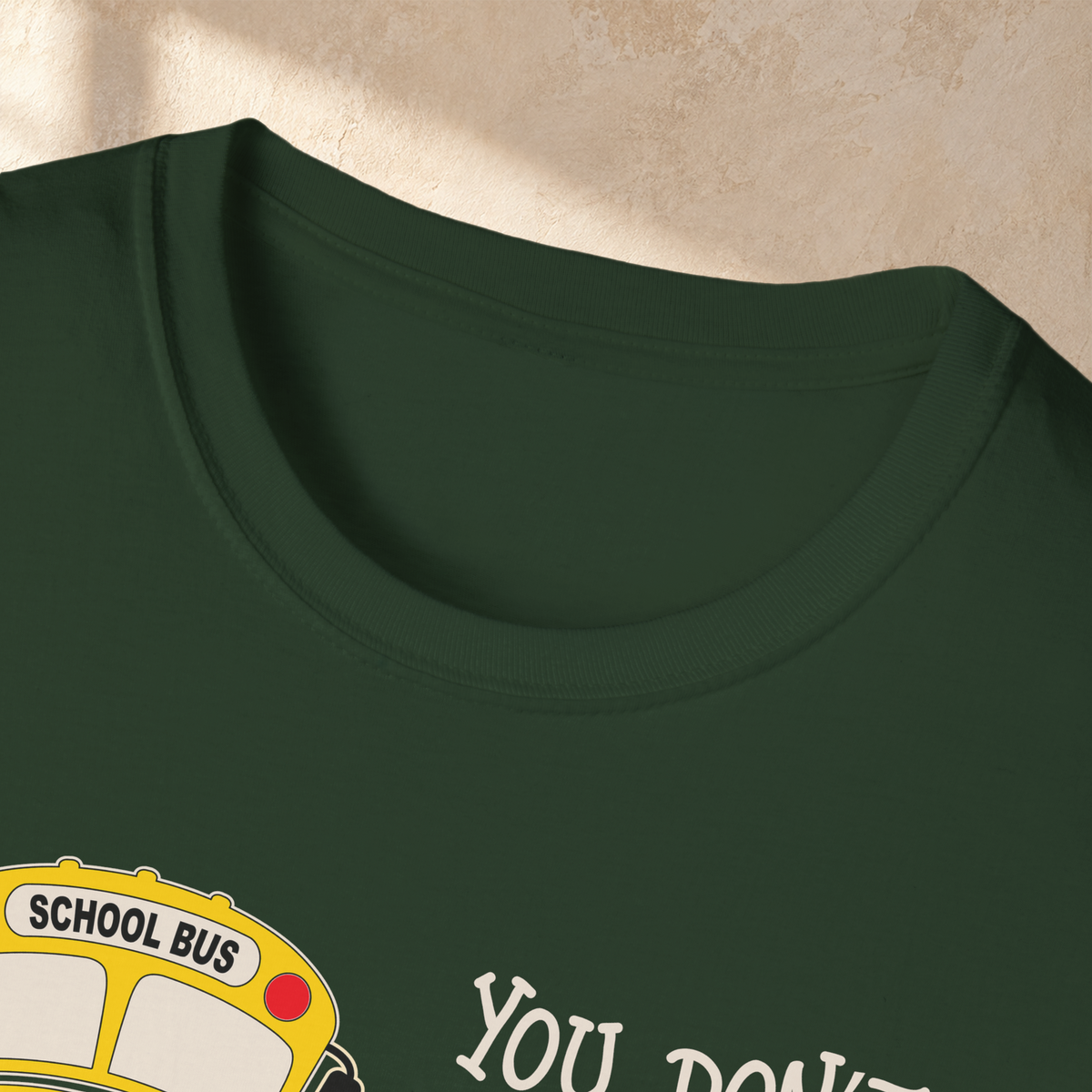 Close-up of the Forest Green Crazy School Bus T-shirt collar and fabric