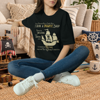 Black Pirate Ship parenting humor graphic T-shirt in a styled lifestyle scene