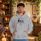 Black Cat Bookshop pullover hoodie in Sport Grey, worn by a standing man