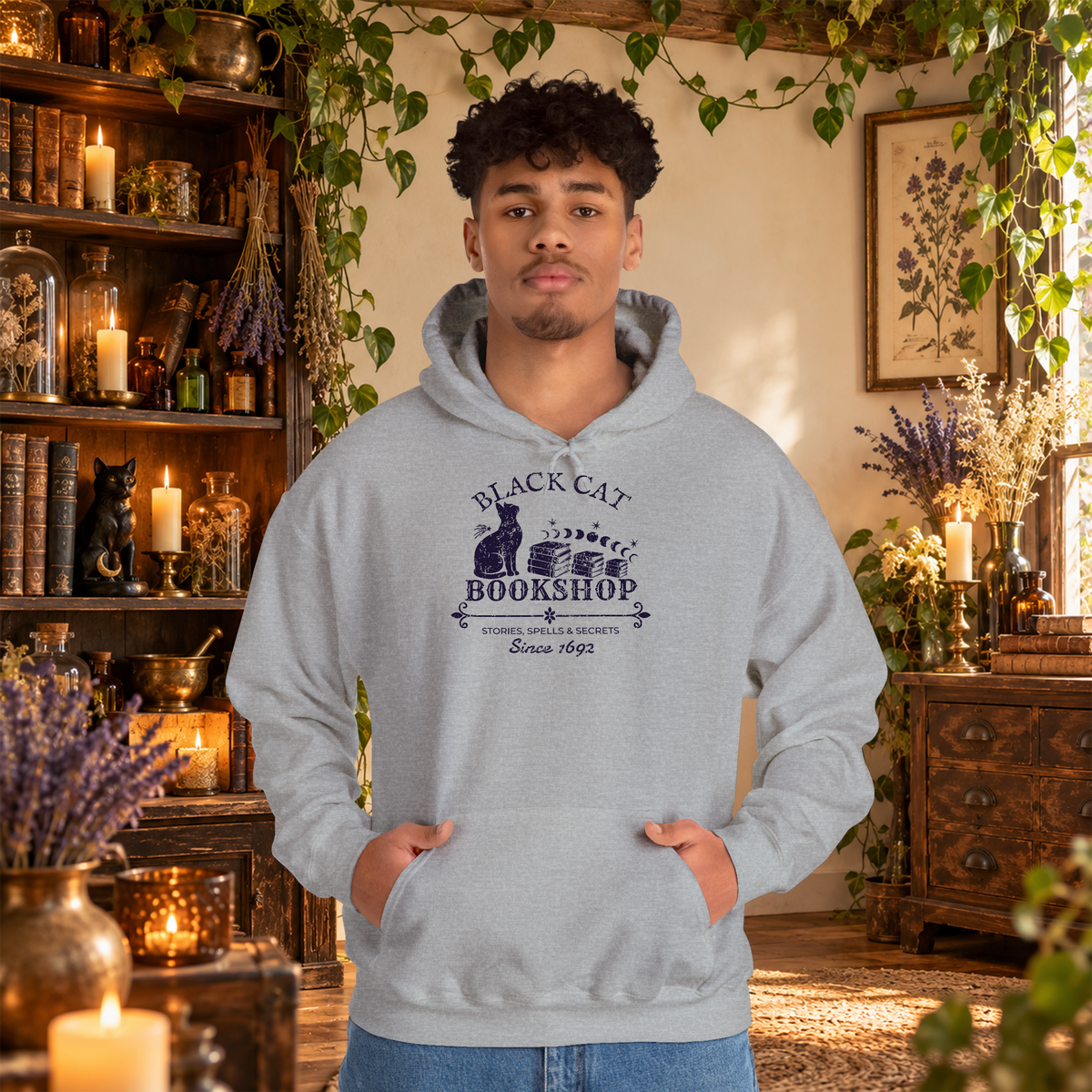 Black Cat Bookshop pullover hoodie in Sport Grey, worn by a standing man