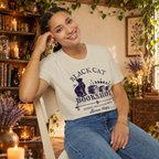 Black Cat Bookshop graphic tee on seated woman
