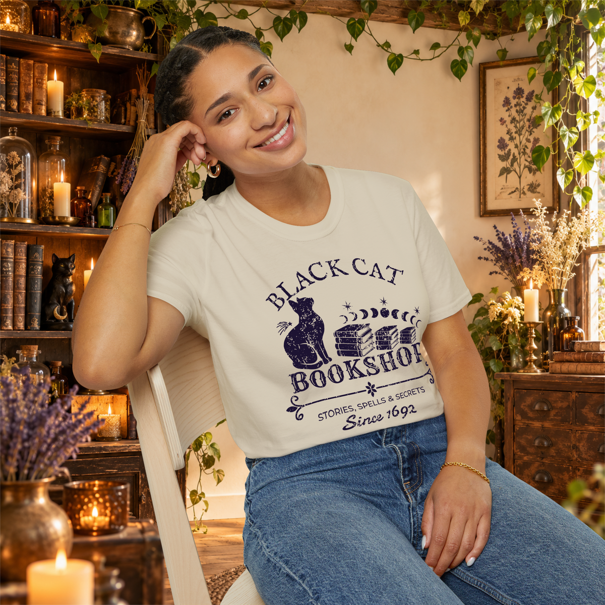 Black Cat Bookshop graphic tee on seated woman