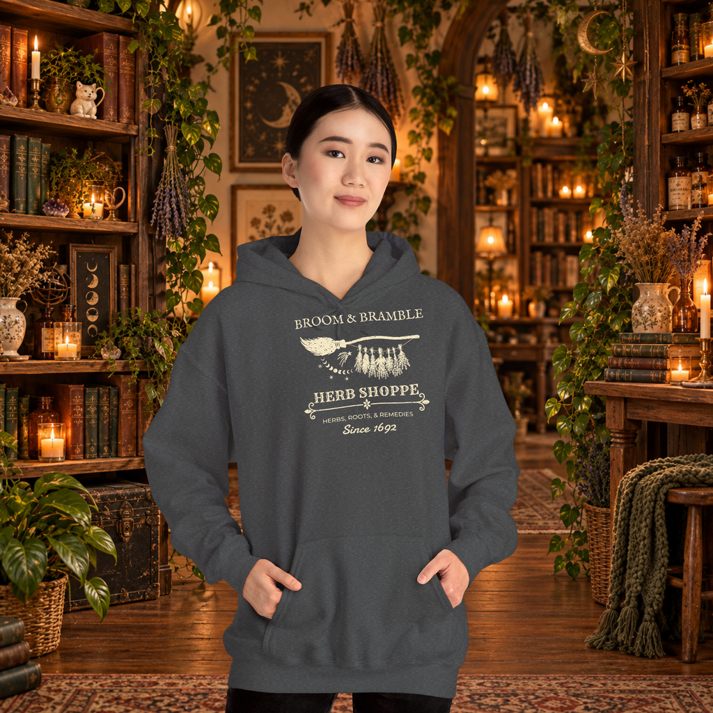 Broom and Bramble pullover hoodie in Dark Heather, worn by a standing woman