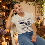 Broom and Bramble graphic tee on seated woman
