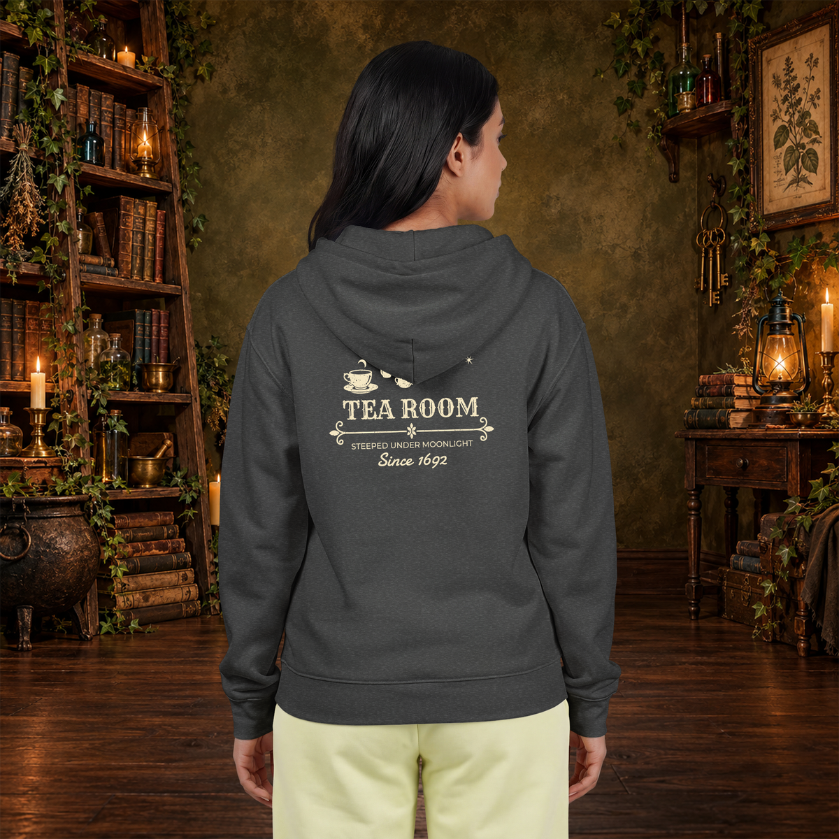 Coven Tea Room full-zip hoodie in Dark Heather, worn by a woman from the back