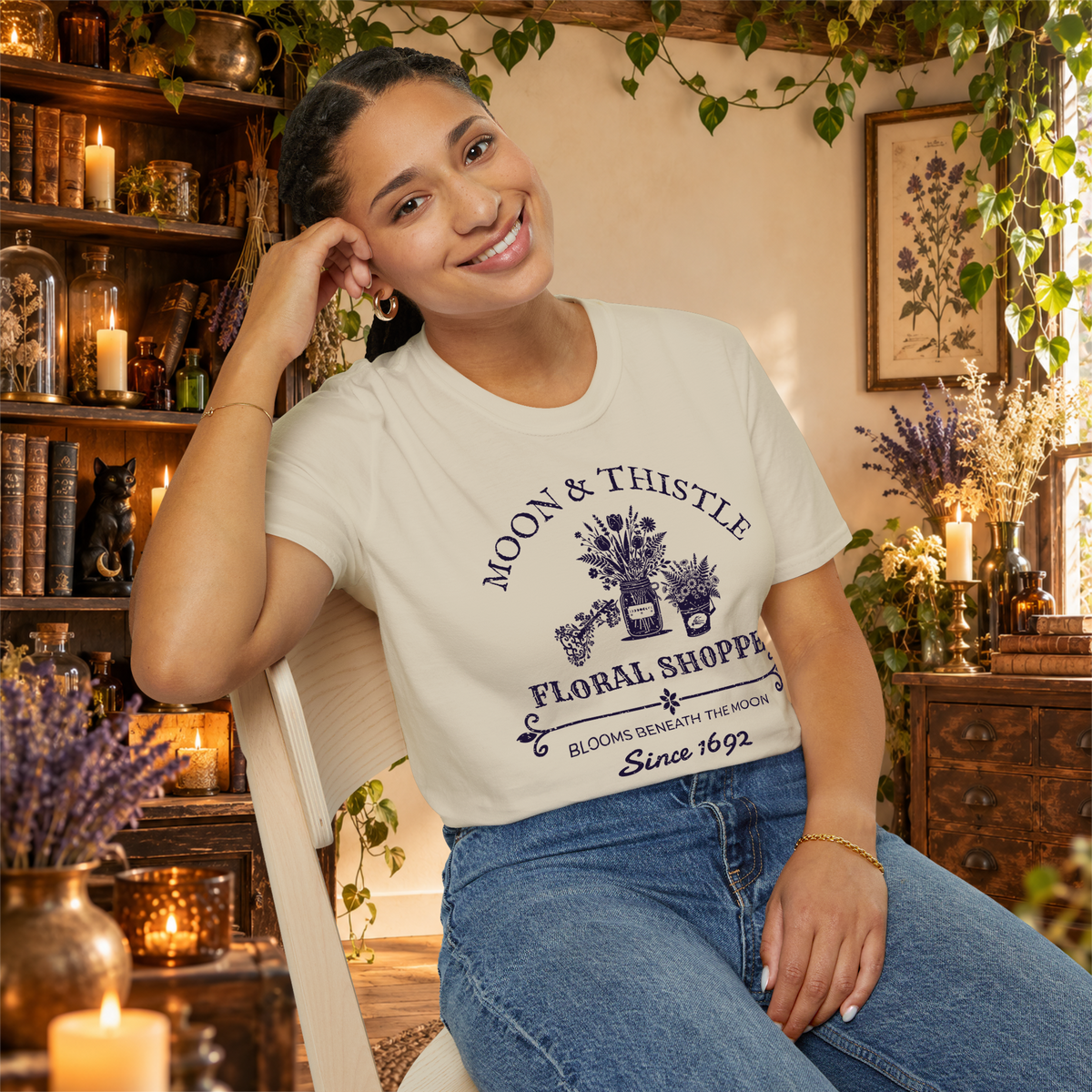 Moon and Thistle graphic tee on seated woman