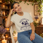 Moonlit Apothecary graphic tee on seated woman
