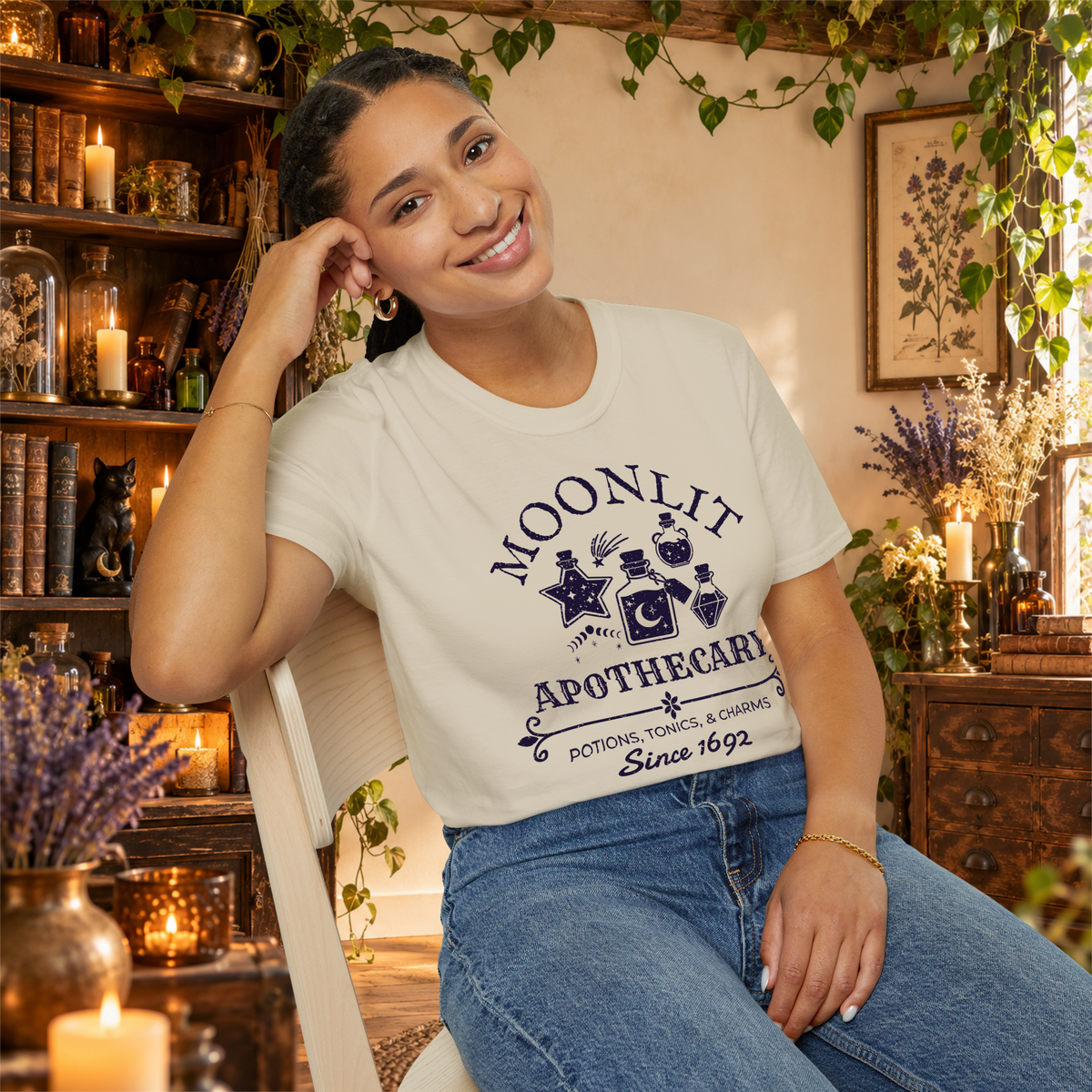 Moonlit Apothecary graphic tee on seated woman