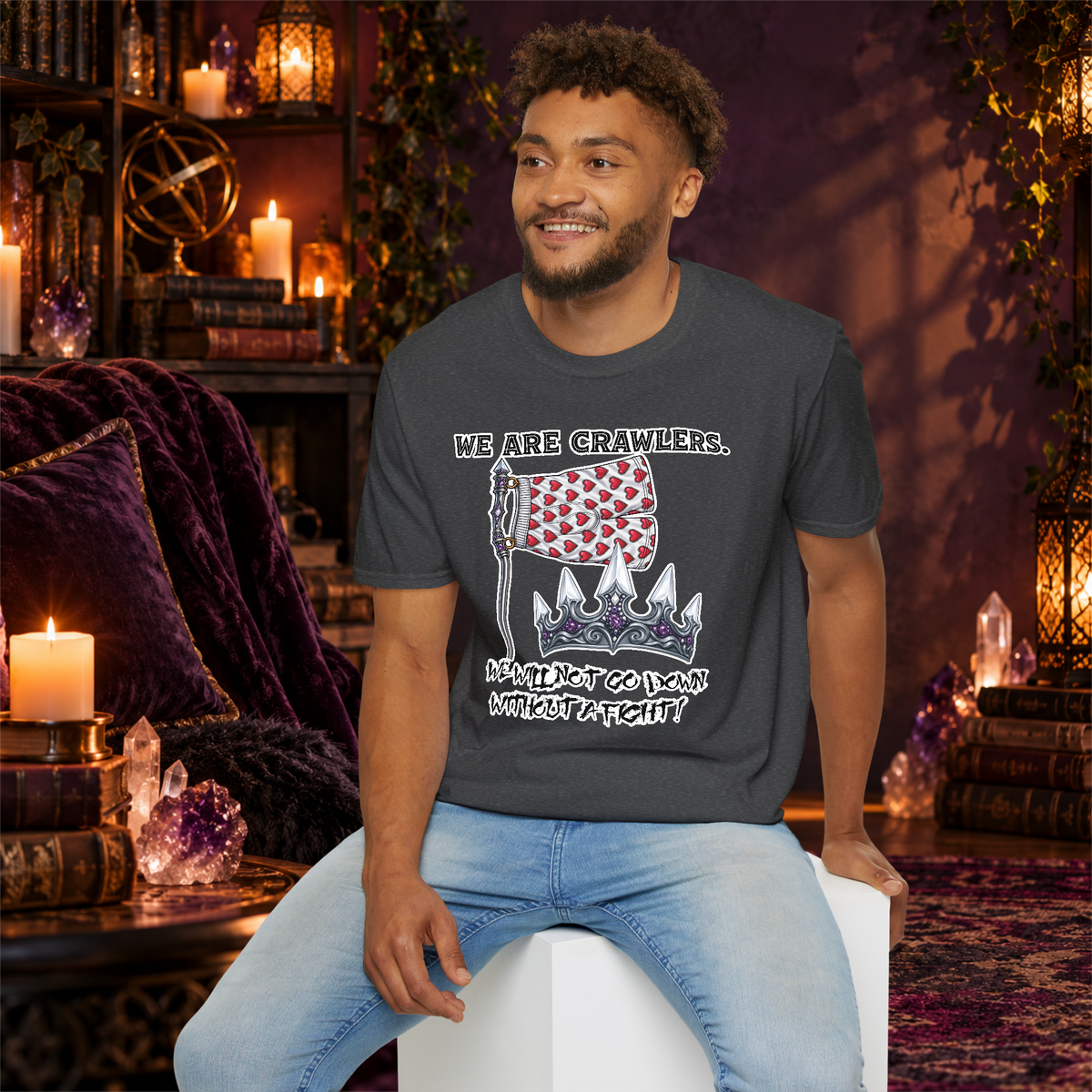 We Are Crawlers graphic T-shirt modeled by a seated man